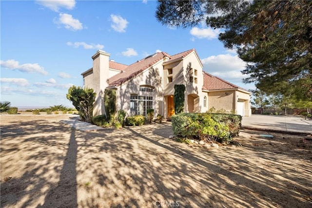 mediterranean / spanish-style house featuring a garage