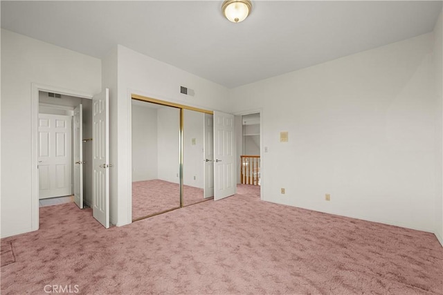 unfurnished bedroom featuring carpet and a closet