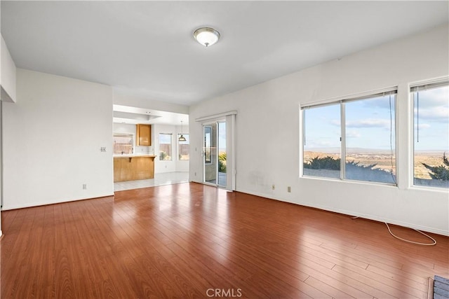 unfurnished living room with hardwood / wood-style floors