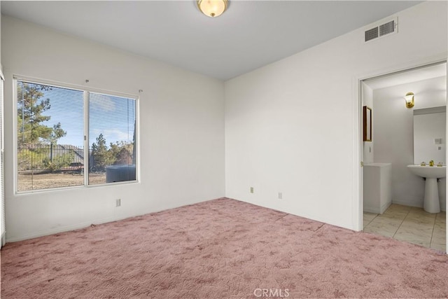 empty room featuring light colored carpet