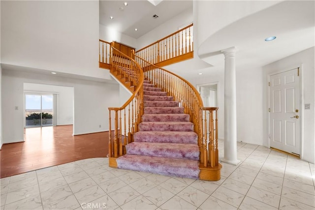 staircase featuring decorative columns