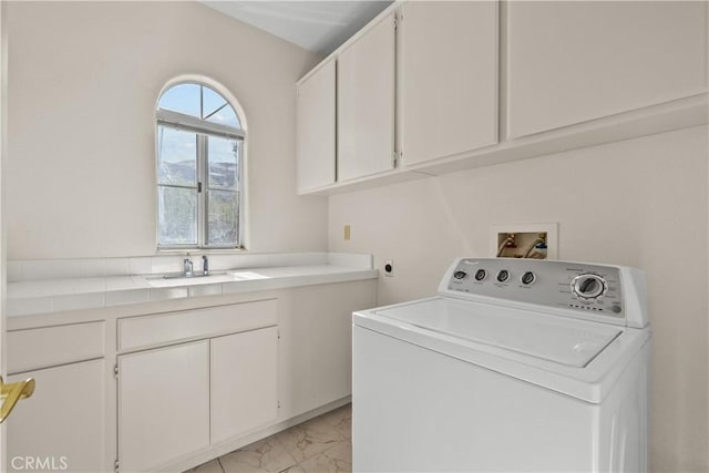 clothes washing area with cabinets, sink, and washer / clothes dryer