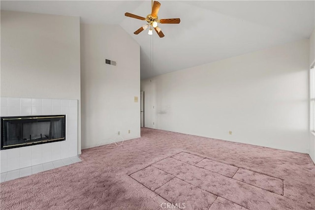 unfurnished living room with a fireplace, lofted ceiling, light colored carpet, and ceiling fan