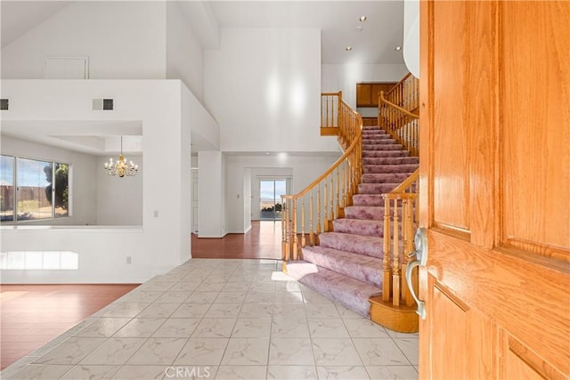 entrance foyer with a towering ceiling and a chandelier