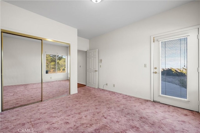 unfurnished bedroom with a closet and carpet floors