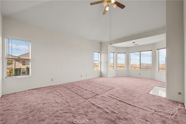 carpeted empty room with ceiling fan and lofted ceiling