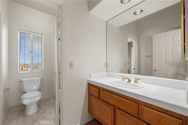 bathroom featuring toilet and vanity