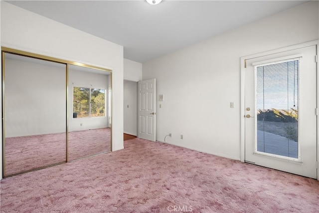 unfurnished bedroom featuring carpet and a closet