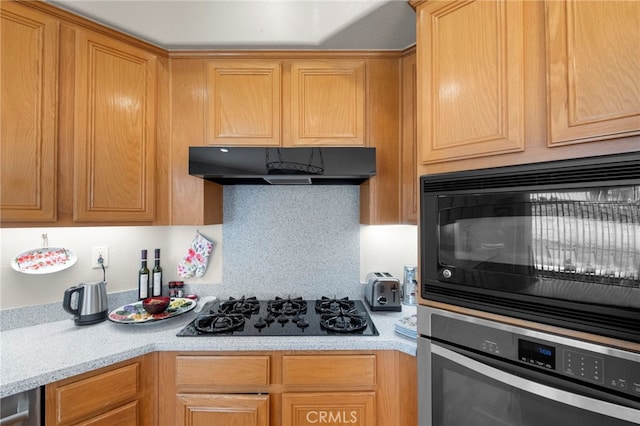 kitchen with under cabinet range hood and black appliances