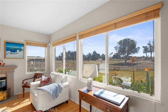 sunroom featuring a glass covered fireplace