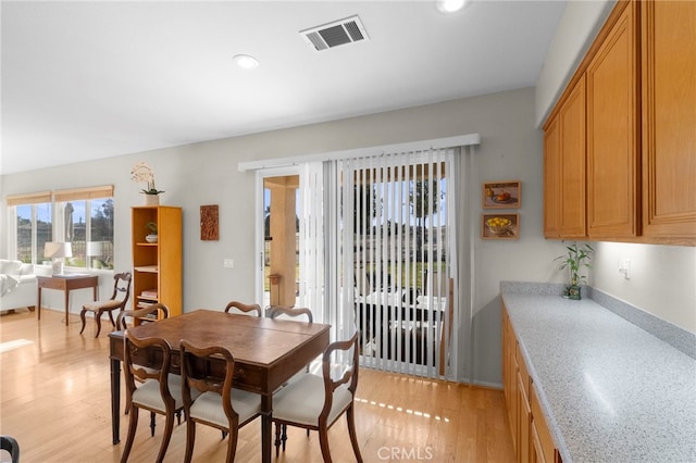 dining room featuring light wood finished floors, visible vents, and recessed lighting