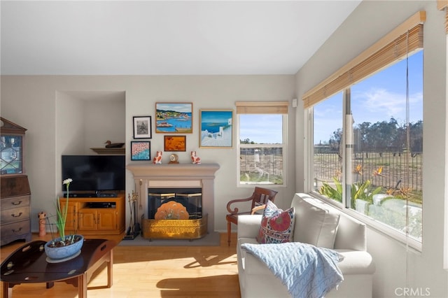 sunroom / solarium with a glass covered fireplace