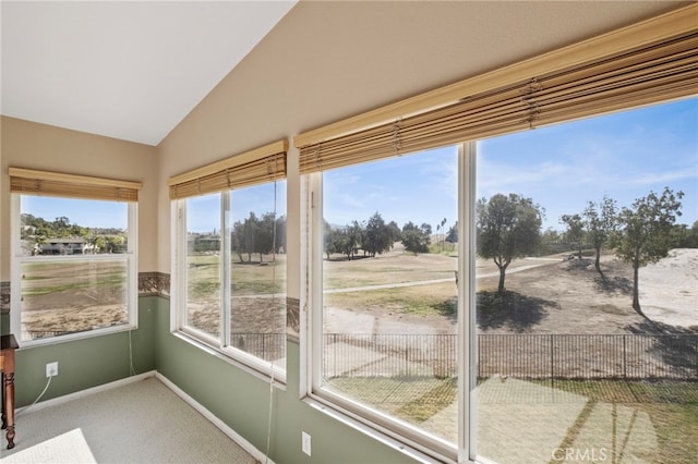 unfurnished sunroom featuring lofted ceiling