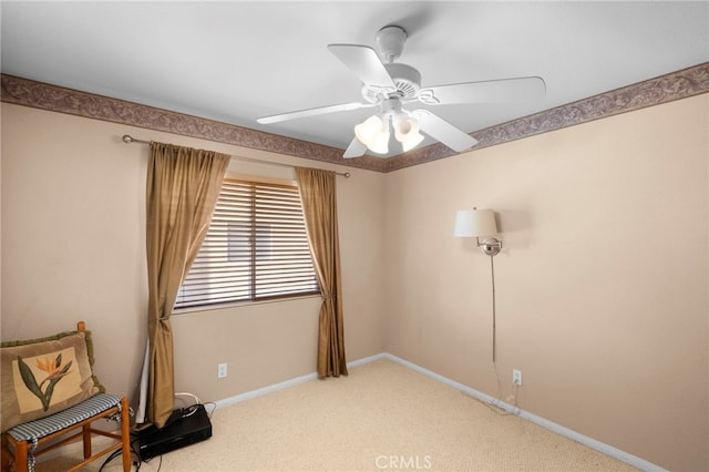 unfurnished room with light carpet, baseboards, and a ceiling fan