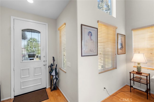 foyer featuring baseboards and light wood finished floors