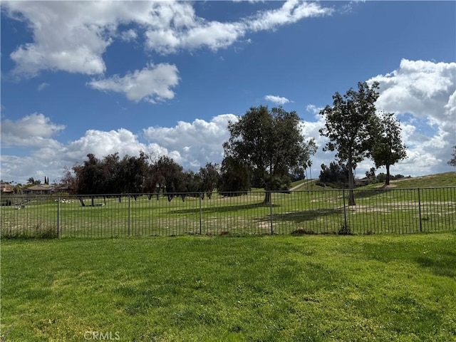 view of yard with a rural view and fence