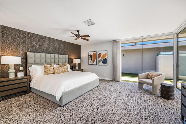 bedroom featuring ceiling fan and expansive windows