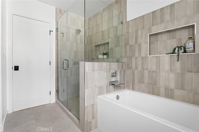 bathroom featuring separate shower and tub and tile patterned flooring