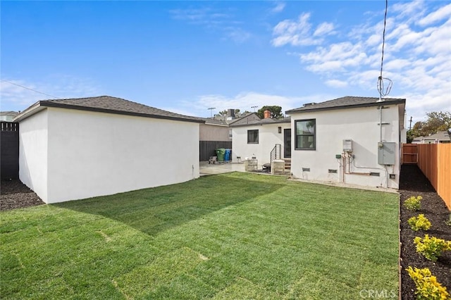 back of property with a patio area and a lawn