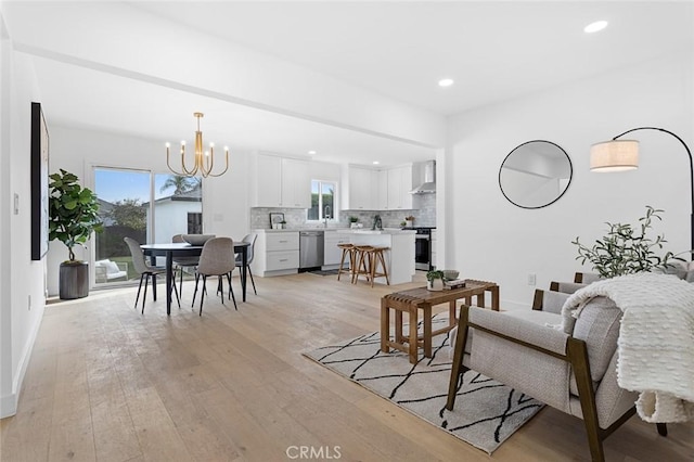 living room with light hardwood / wood-style flooring and a chandelier