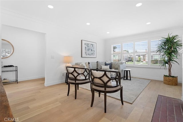 dining space featuring light hardwood / wood-style flooring and ornamental molding