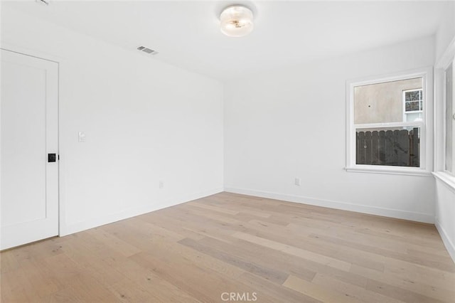 spare room featuring light hardwood / wood-style floors