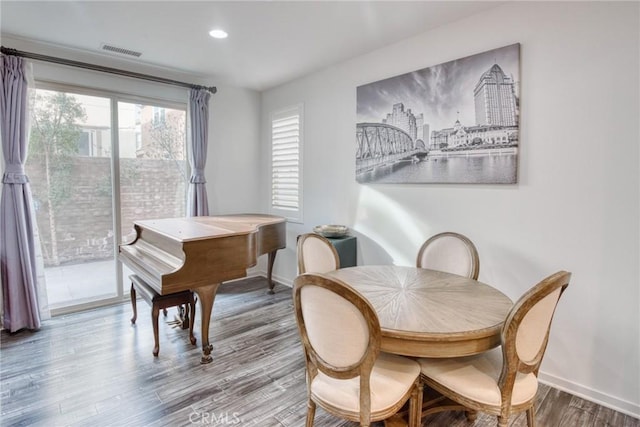 dining space with recessed lighting, wood finished floors, visible vents, and baseboards