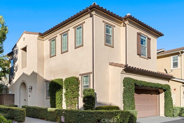 mediterranean / spanish home featuring a garage