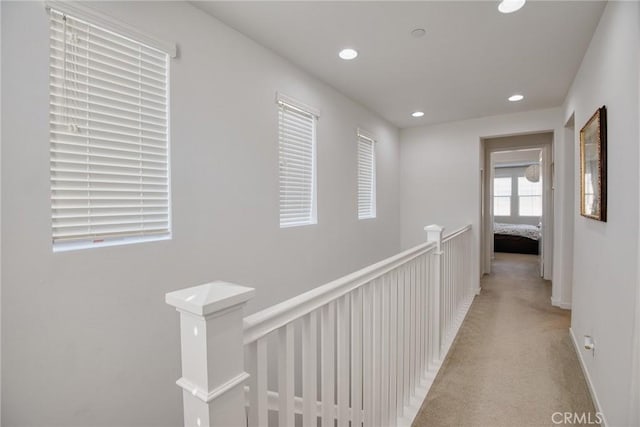 corridor featuring light carpet, an upstairs landing, and recessed lighting