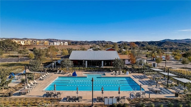 pool featuring a patio area and a mountain view