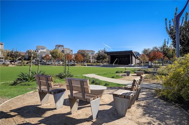 view of home's community featuring a residential view and a lawn