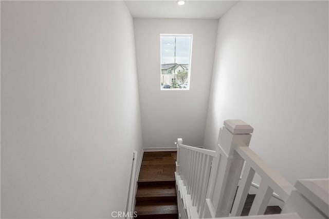 stairs featuring hardwood / wood-style flooring