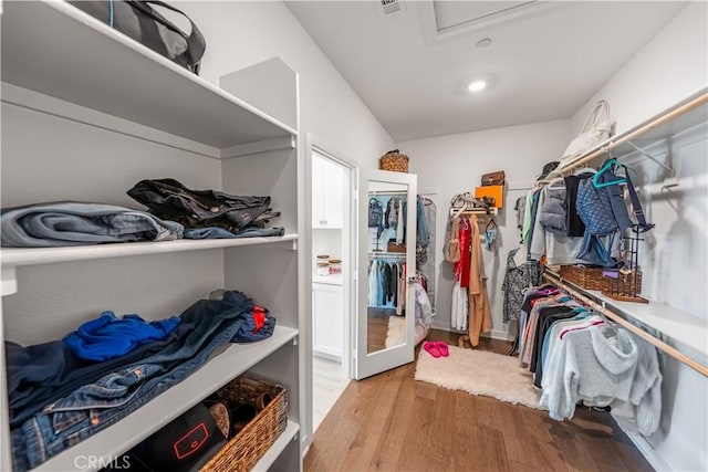 walk in closet with light wood-type flooring