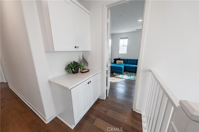 corridor with dark hardwood / wood-style flooring