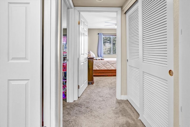 corridor featuring light colored carpet