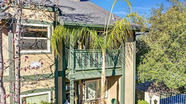 view of side of home featuring a balcony