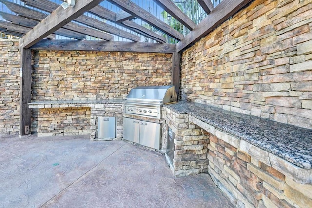 view of patio with a pergola, area for grilling, and exterior kitchen