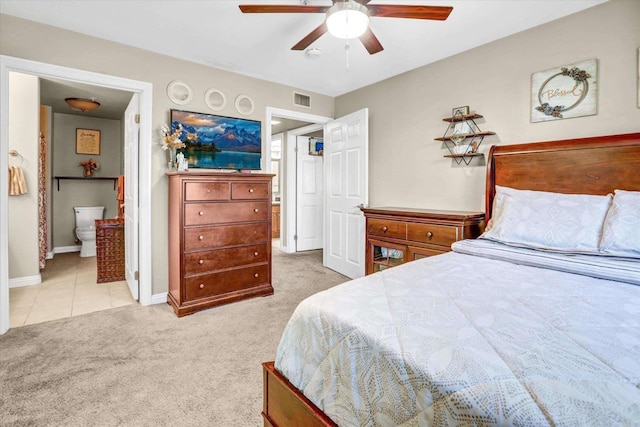 carpeted bedroom featuring ensuite bath and ceiling fan