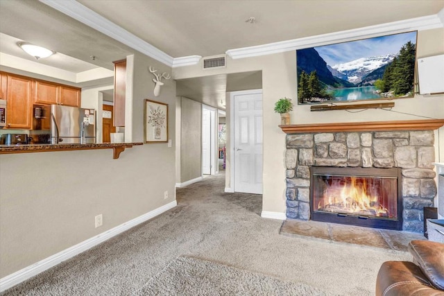 carpeted living room with a fireplace and ornamental molding