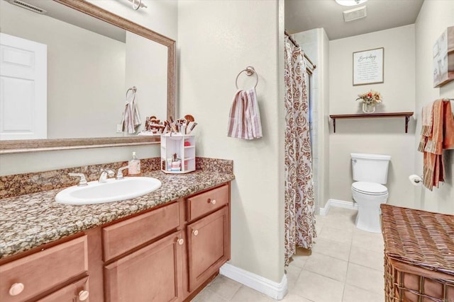 bathroom featuring toilet, vanity, and tile patterned floors