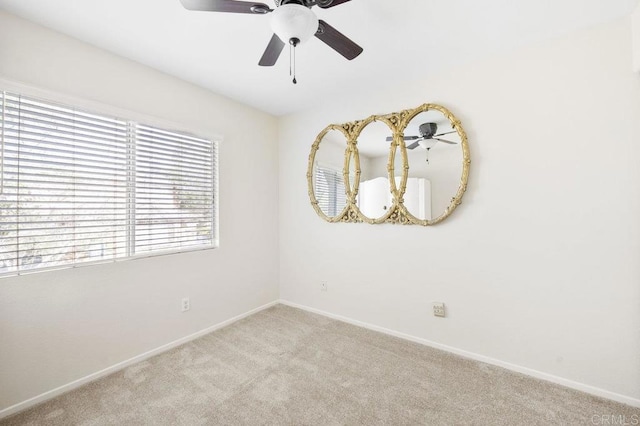 carpeted empty room featuring ceiling fan