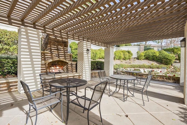 view of patio / terrace featuring a pergola and an outdoor stone fireplace