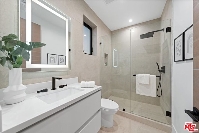 bathroom with an enclosed shower, vanity, and toilet