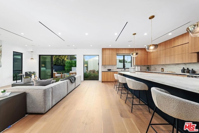 living room with sink and light hardwood / wood-style flooring