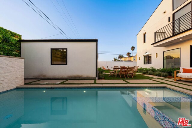 view of swimming pool with an outbuilding