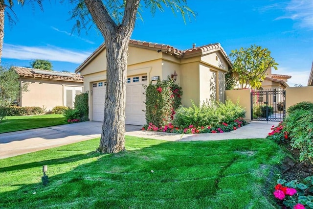 view of front of property with a garage and a front lawn