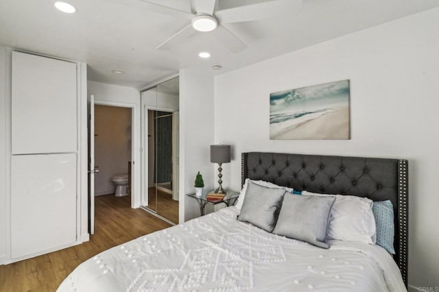 bedroom featuring ceiling fan, a closet, connected bathroom, and hardwood / wood-style floors