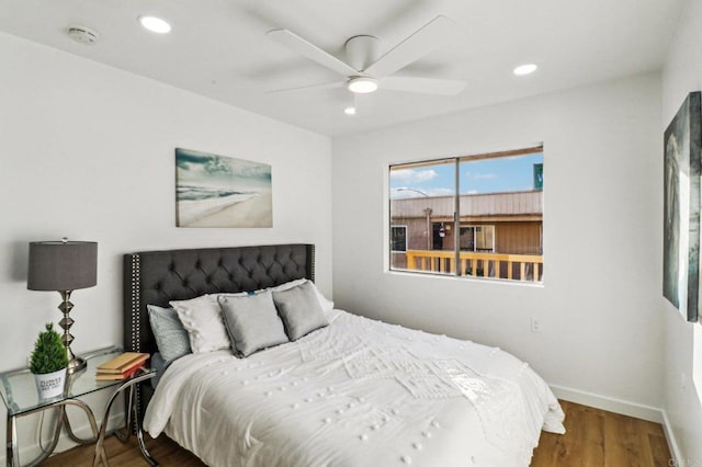 bedroom with ceiling fan and dark hardwood / wood-style floors