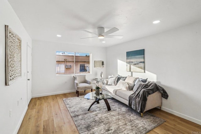 living room featuring ceiling fan and hardwood / wood-style floors