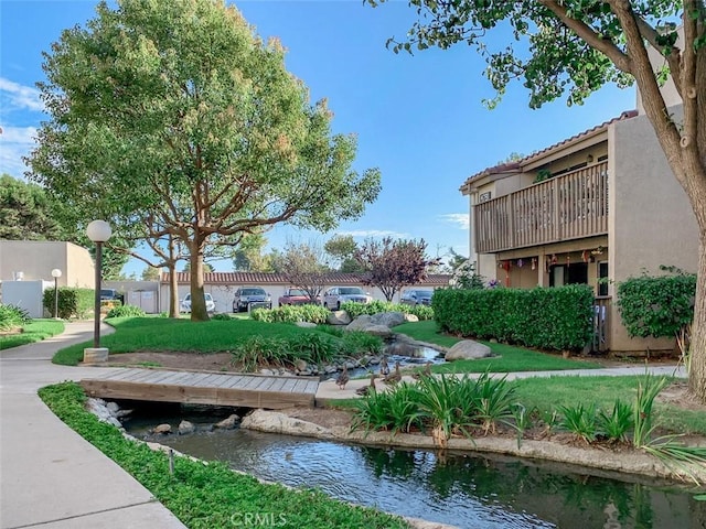 view of home's community with a lawn